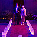 Gala guests arrive on luminaria-lined red carpet path